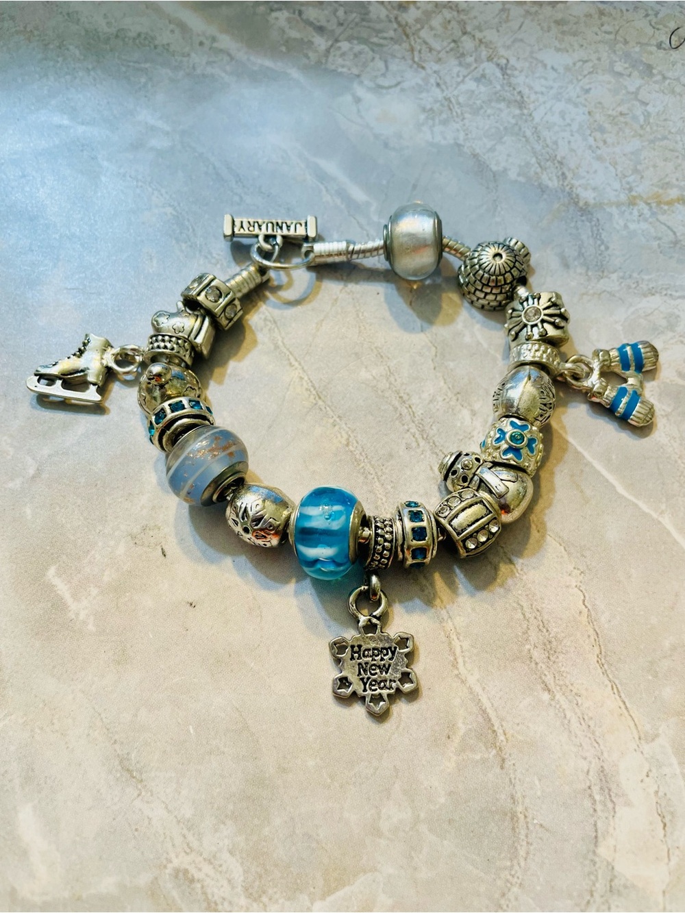 January Silver Charm Bracelet w/Blue Glass Beads & Happy New Year' Pendant. 8 in